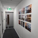 Hallway with images on it and fire door at the back